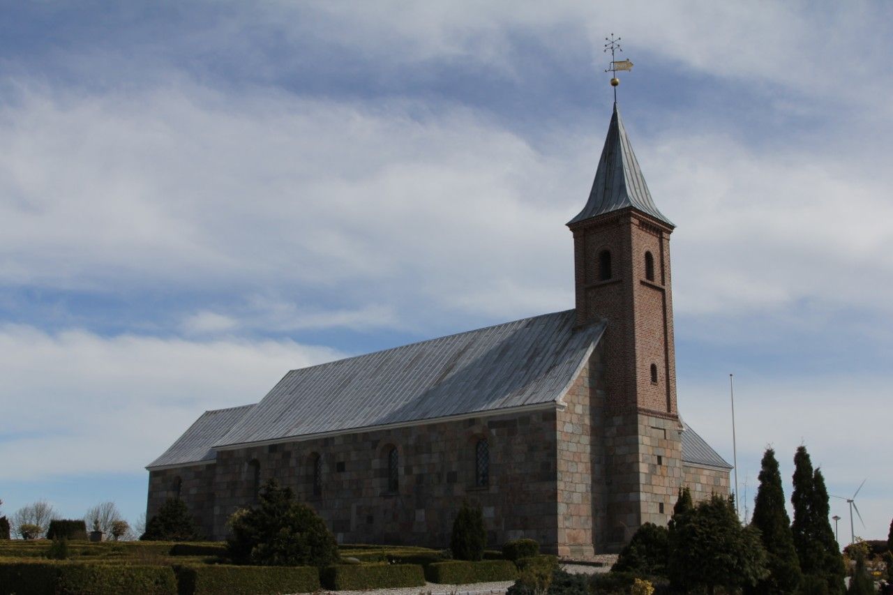Haslund kirke set fra kirkegården, med tårnet i forgrunden